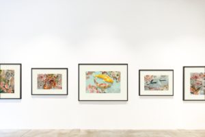 Framed paintings on a gallery wall representing the paintings at issue in an estate dispute