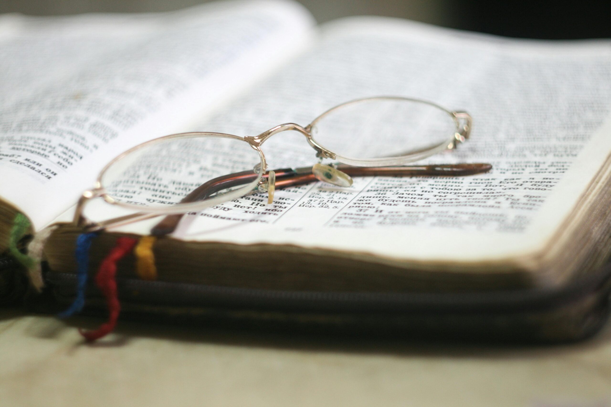 Book with reading glasses representing a glossary fiduciary duty in estates law