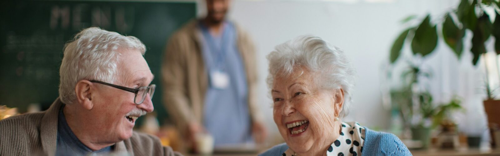 A senior man and woman laughing while eating, representing substitute decision-making in Ontario